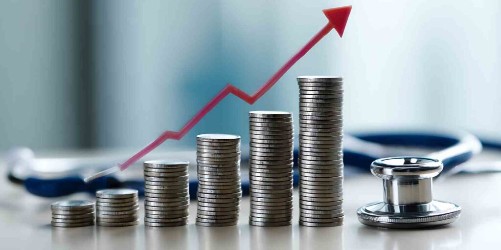 Rising Group Health Insurance Costs Represented by Coins and a Stethoscope