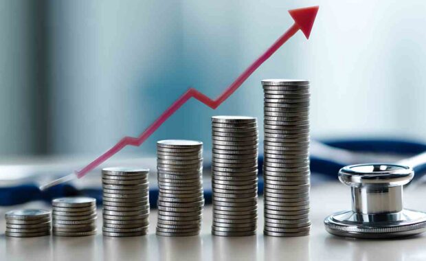 Rising Group Health Insurance Costs Represented by Coins and a Stethoscope