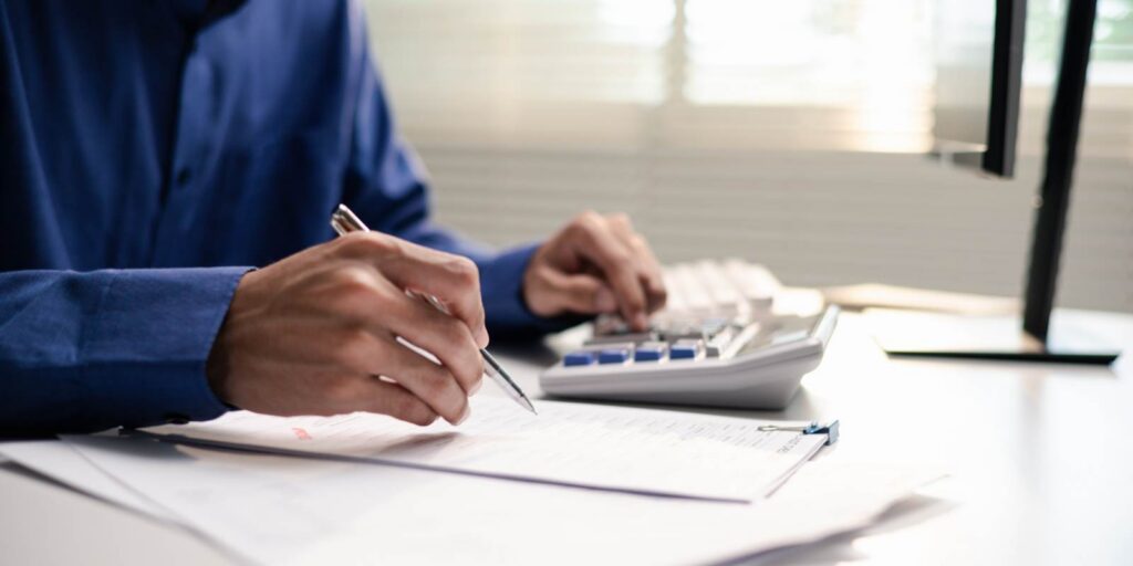 Honolulu Business Owner Calculating Insurance Premium in Office